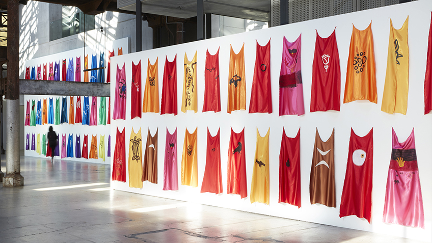 colourful capes hanging on a wall