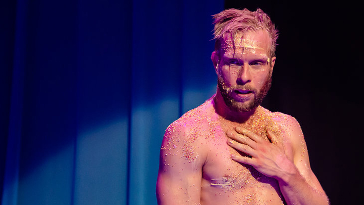 Joel Bray performing on stage.