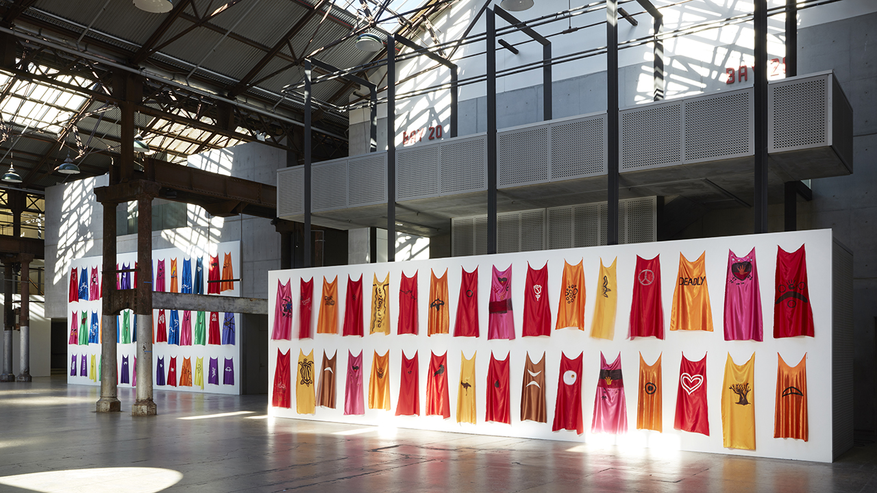 colourful capes hanging on a wall