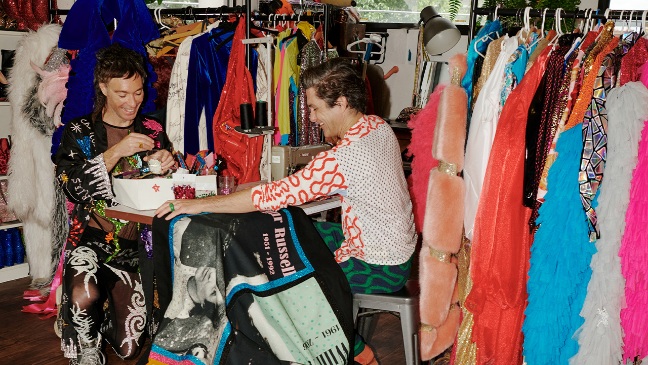 Garrett and Will Huxley sewing a quilt in their studio.