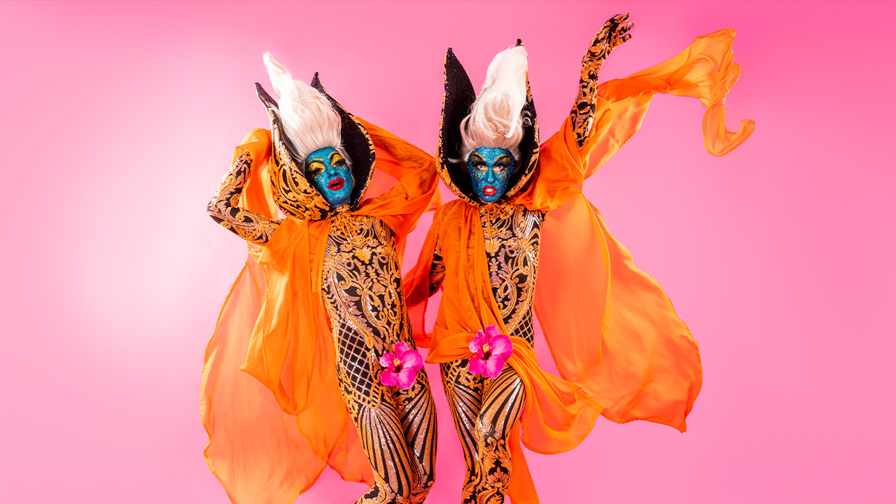 The Huxleys dress in orange against a pink background