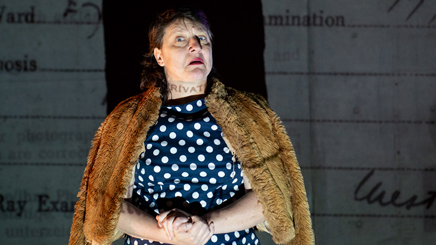 Kaz Therese dressed in a blue polkadot dress and fur jacket.